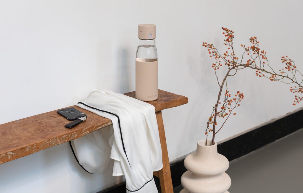 Picture of Ukiyo glass hydration tracking bottle with sleeve